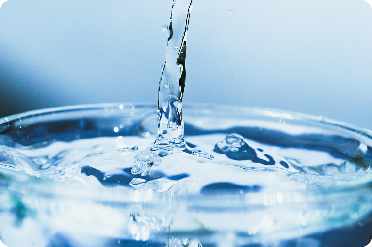 Clear spring water pouring into a glass